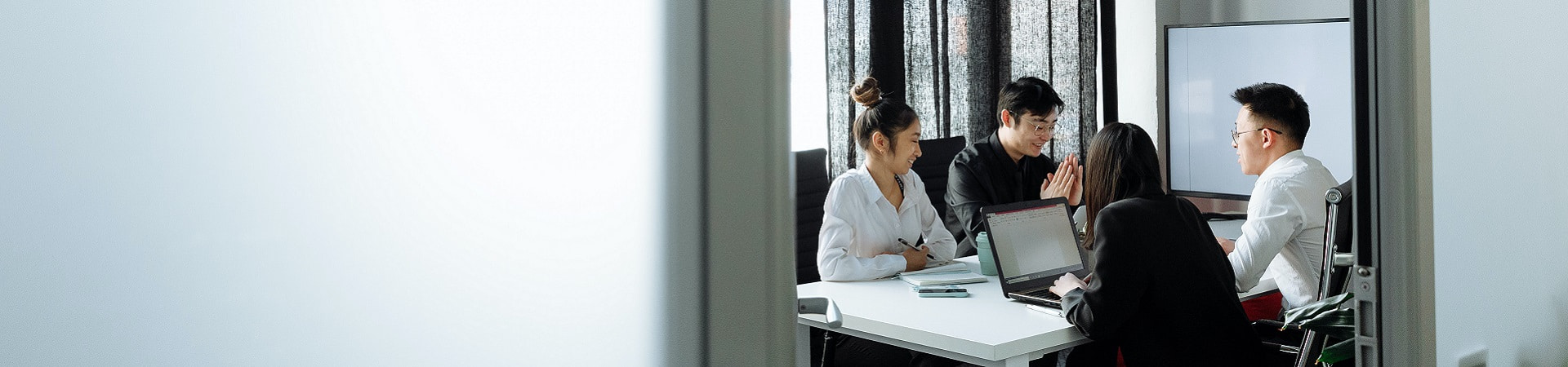 Four people in a meeting room