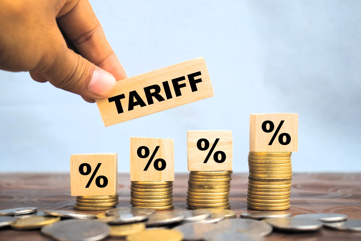tariff sign on a stack of coins