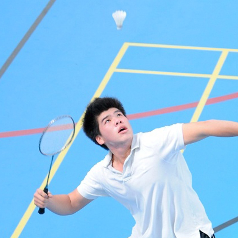 a boy playing badminton